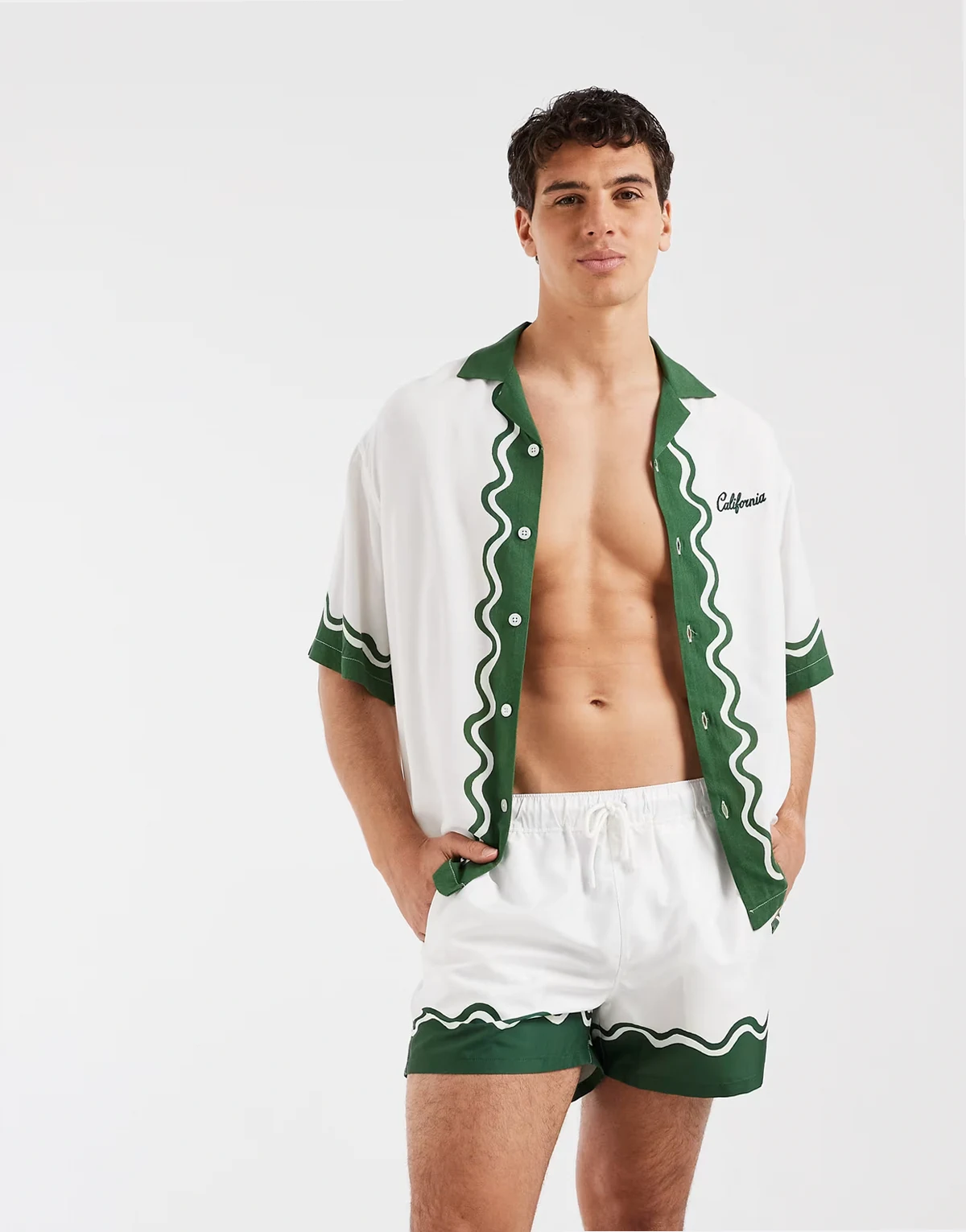 short length swim shorts with border print in off white - part of a set