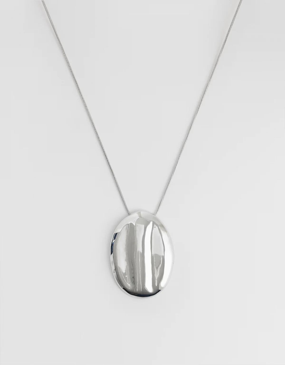 long snake chain necklace with large oval pendant in silver tone