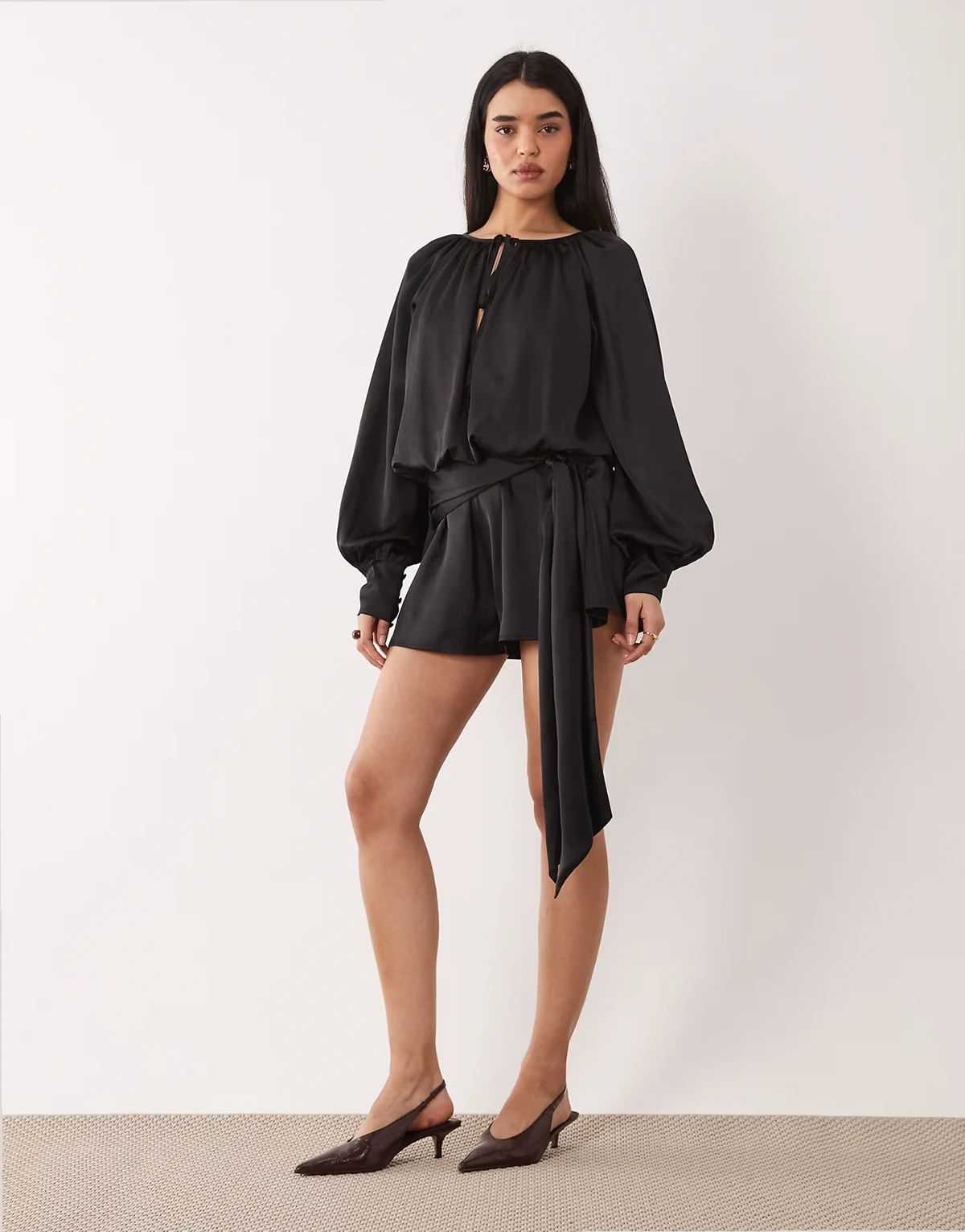 satin long sleeve romper with tie detail in black