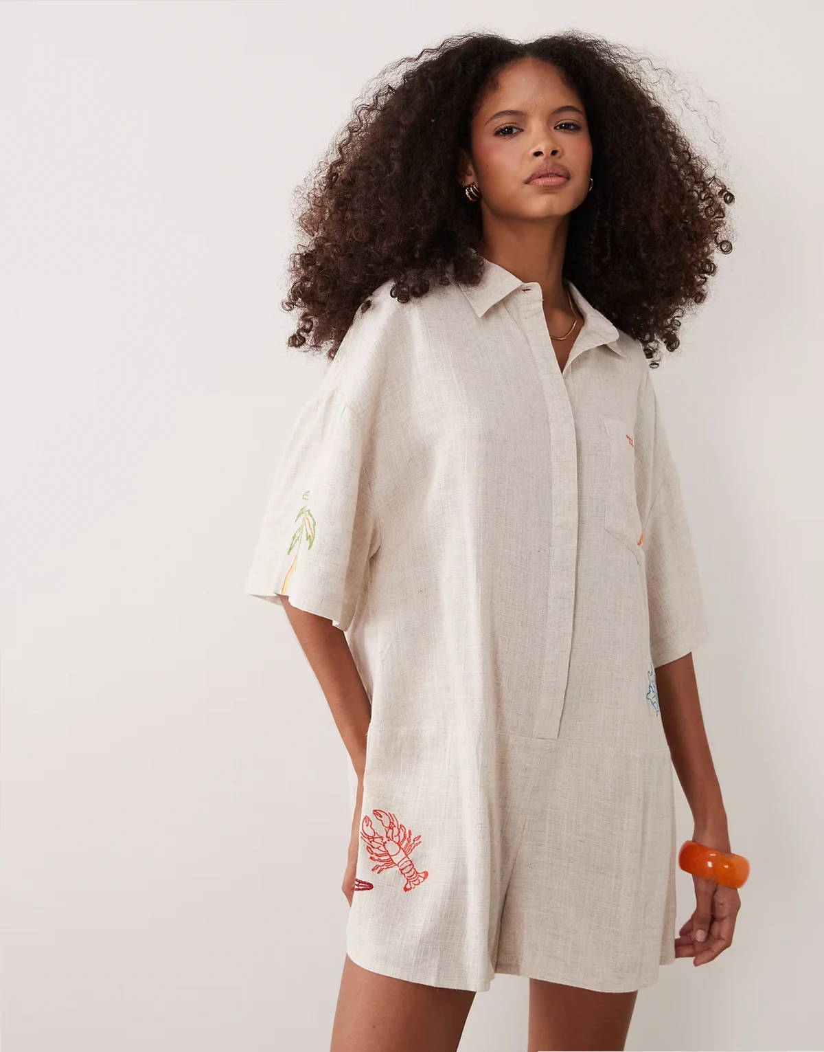 short sleeve romper with embroidery detailing in stone